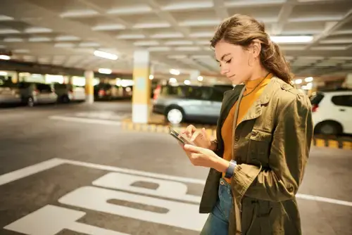Woman on her phone in an underground car park